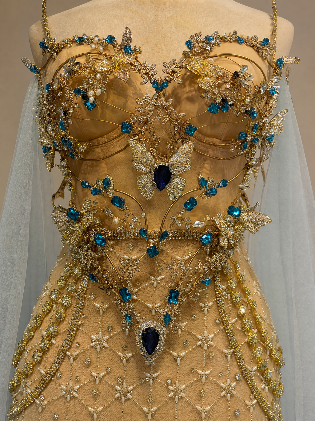 Champagne Gold Cape Floral Pageant Gown — couture detail view (source SKU-045) — reviewed generated product image