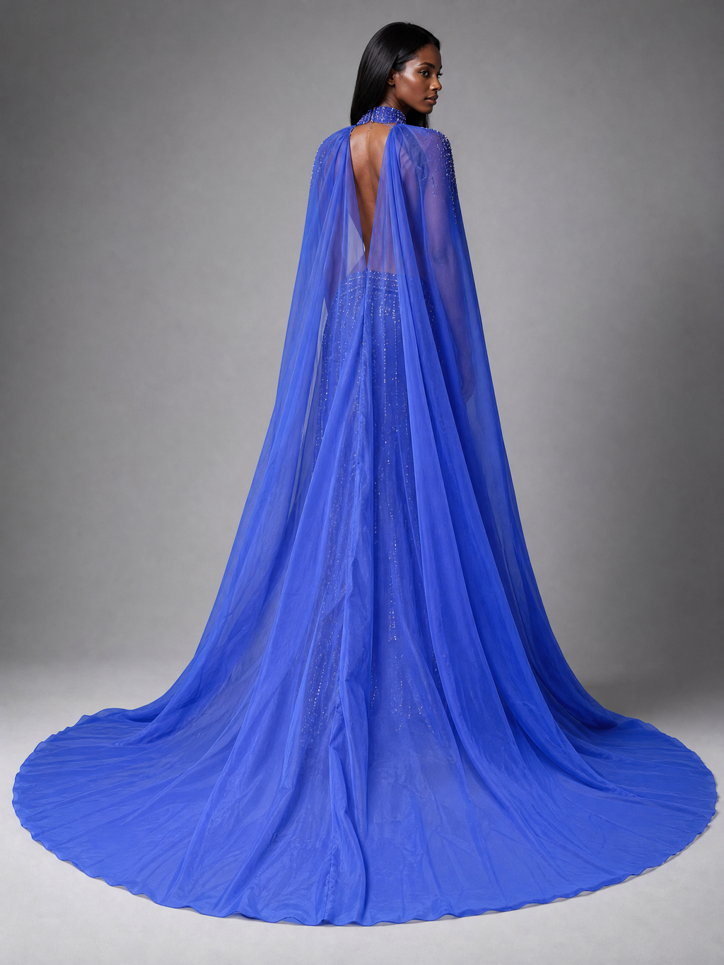 Royal Blue Tulle Cape and Train Pageant Gown — side or back view (source SKU-042) — reviewed generated product image